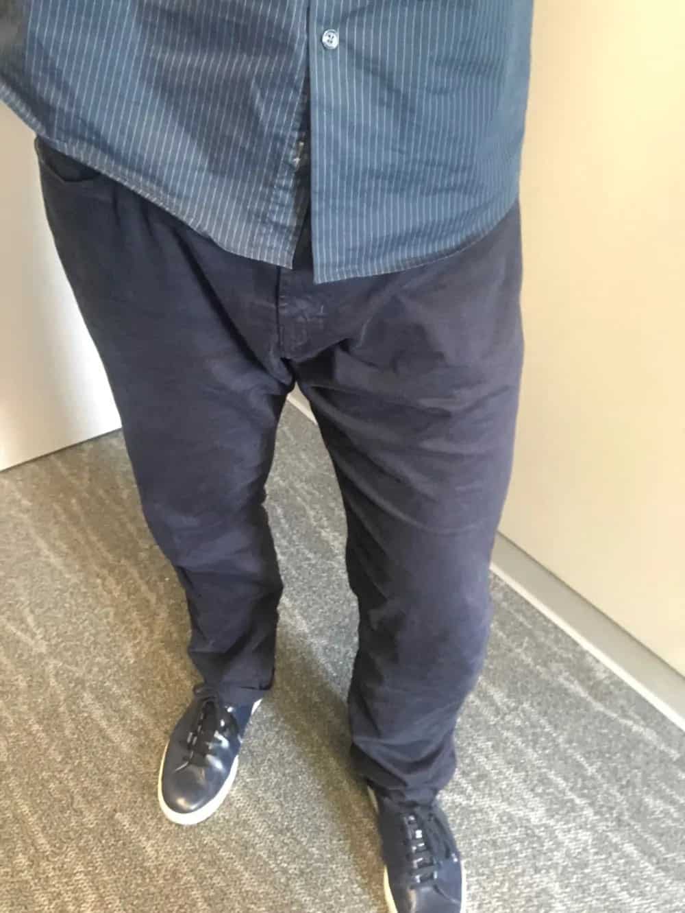 AG 5 pocket blue cotton pants for men with untucked shirt.