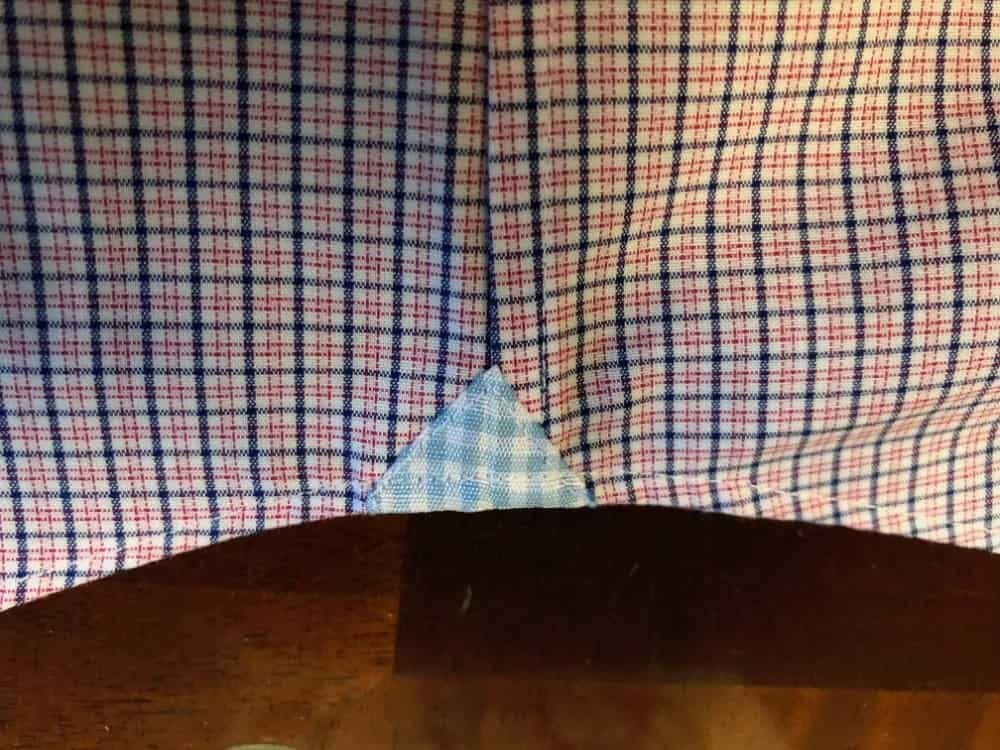 Close-up photo of the bottom side seam for Banana Republic men’s slim fit dress shirt.