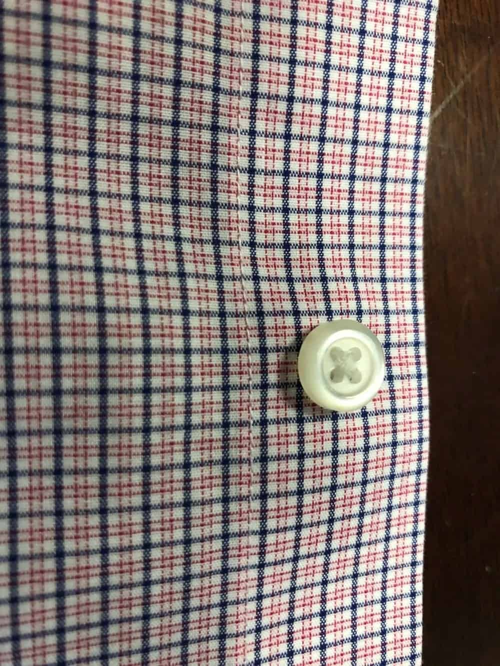 Close up photo of the buttons used on Banana Republic men’s slim fit non-iron dress shirt.