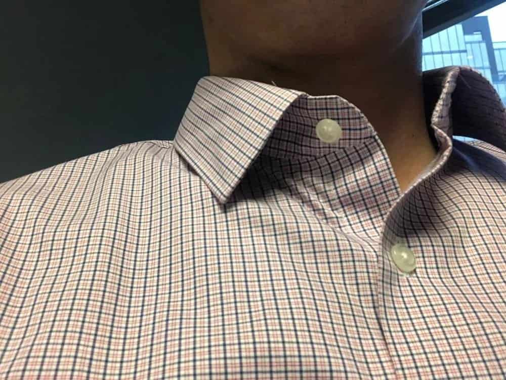 The 2nd top button is placed at a good location. Not too far down, nor too far up.