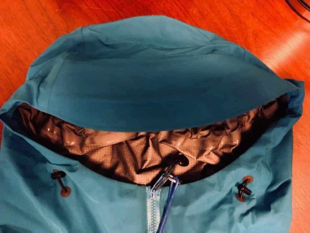 Front view of hood of Arc’Teryx Beta LT jacket. Hood adjustments to left and right of zipper.