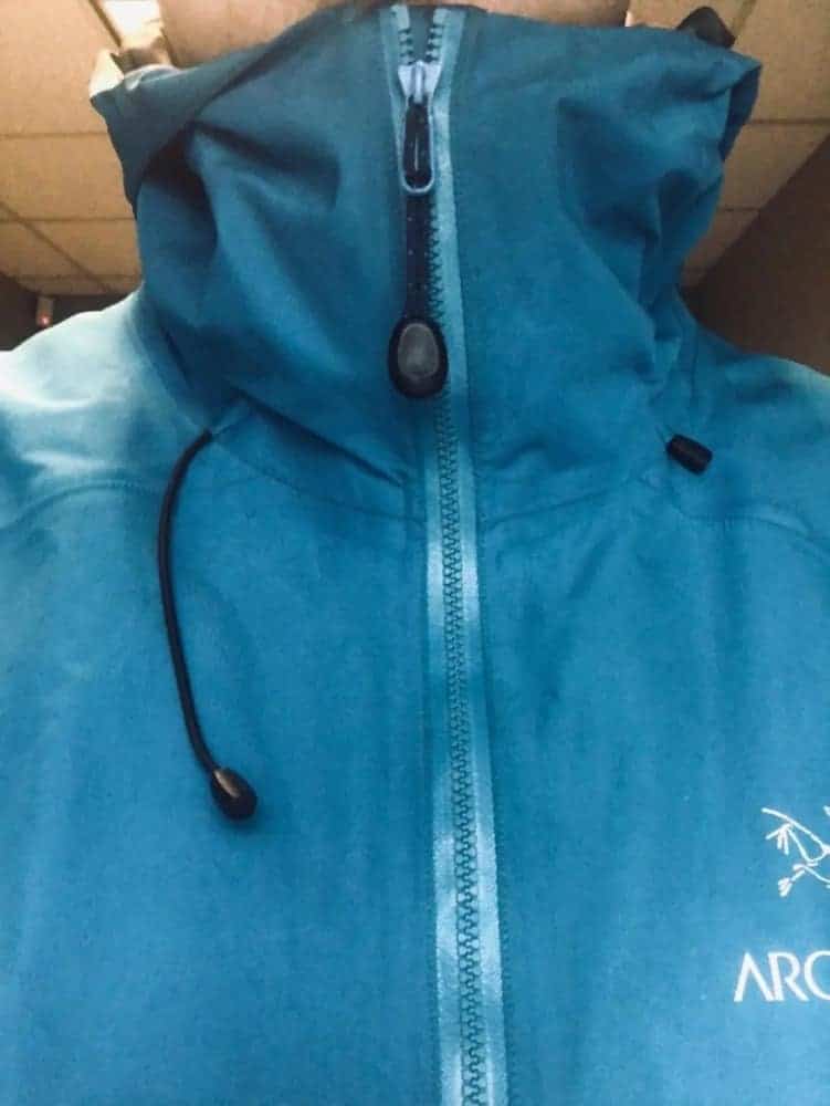 Close-up front view of zipped up Arc’Teryx Beta LT jacket. Notice the extensive neck protection when zipped up.