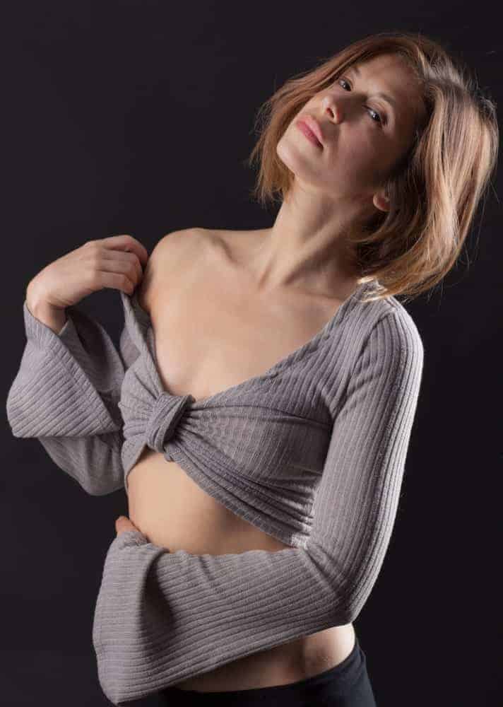 Woman in a crop top bell sleeves sweater.