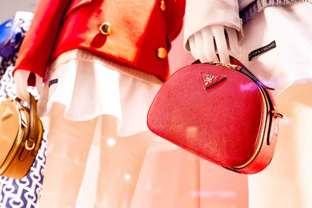 Mannequins holding Prada bowling bags.