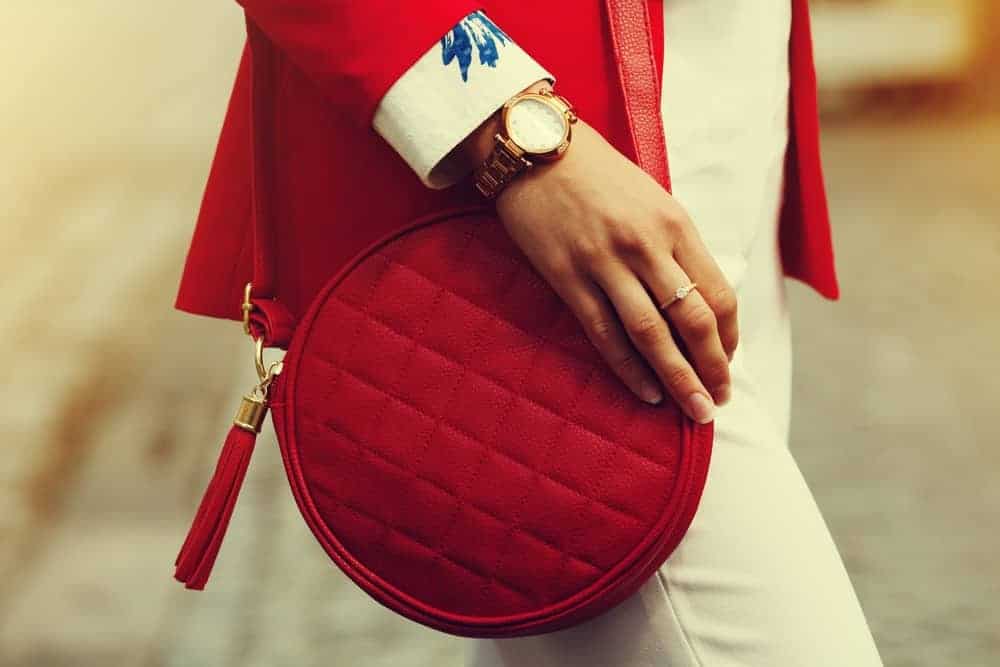 Woman with red quilted leather handbag.