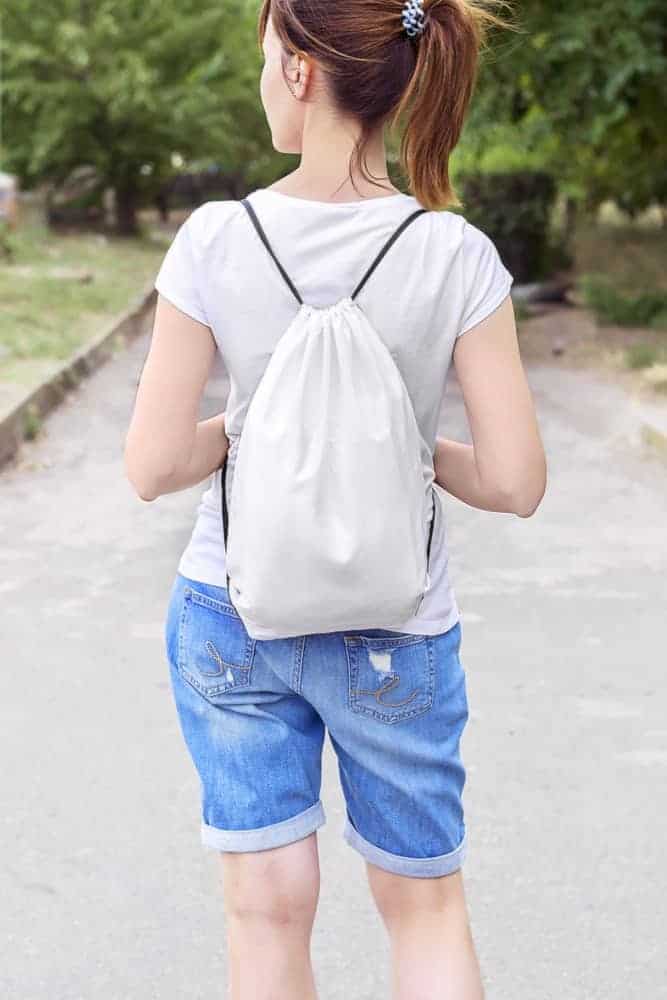 Woman with drawstring bag.