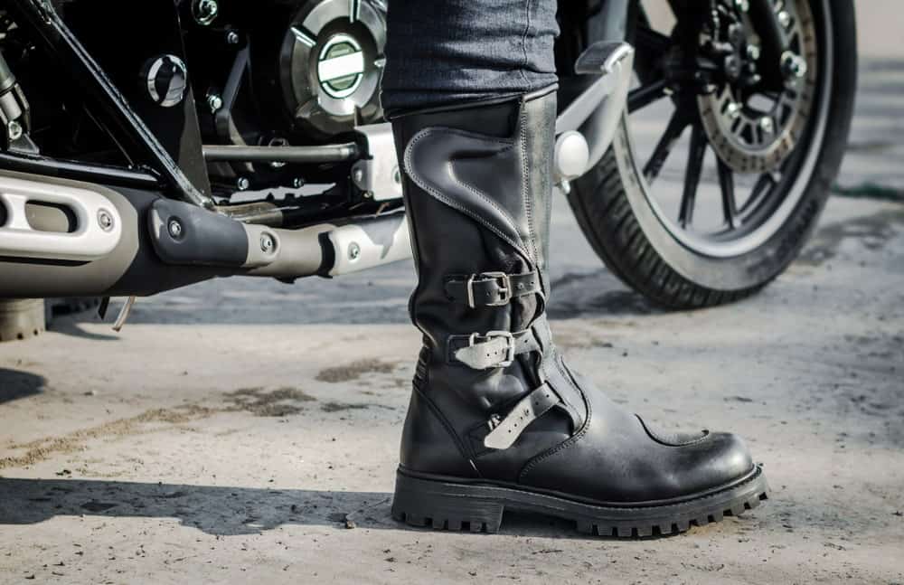 A man on a bike wearing an engineer boot.