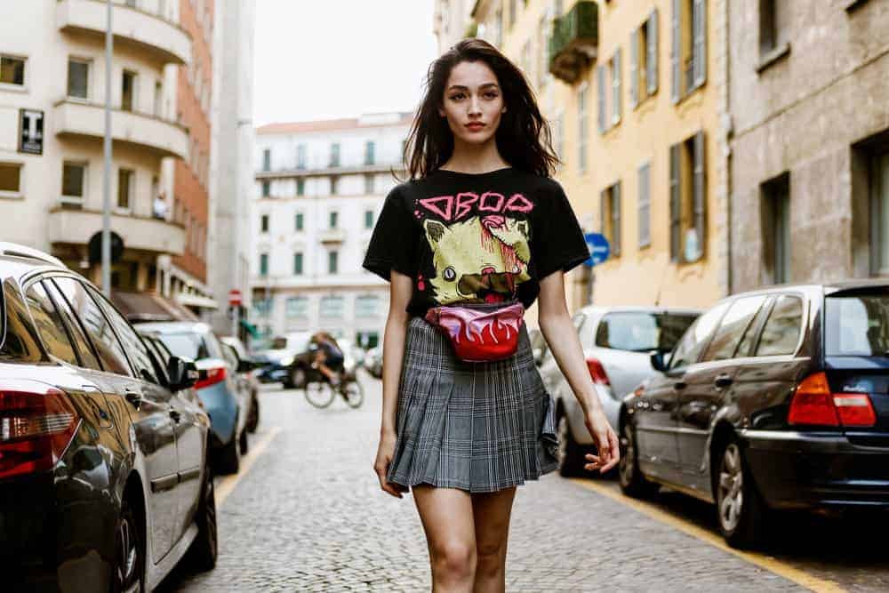 Woman wearing a red fanny pack.