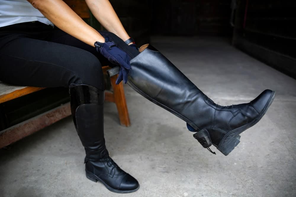 An equestrian wearing gumboots.