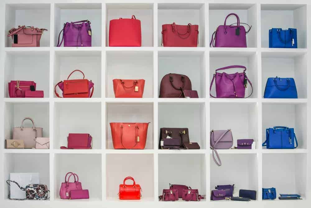 Display of multicolored handbags in a store.