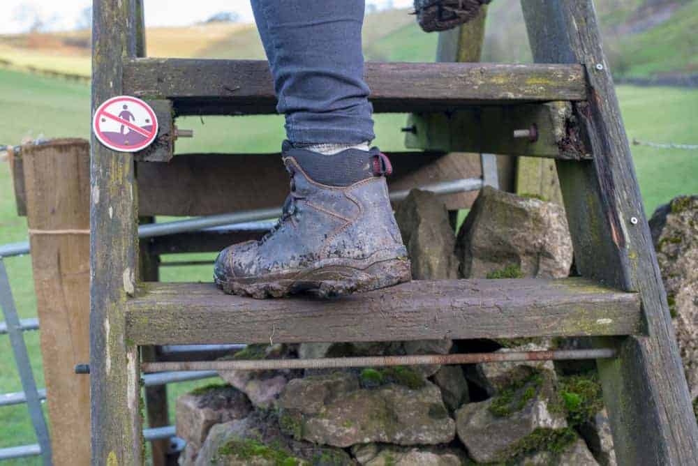  A hiker in hobnail boots climbing a ladder.
