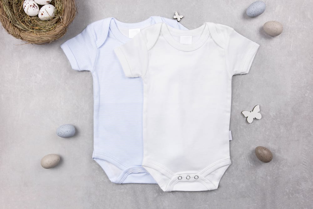 A couple of onesies against the gray background.