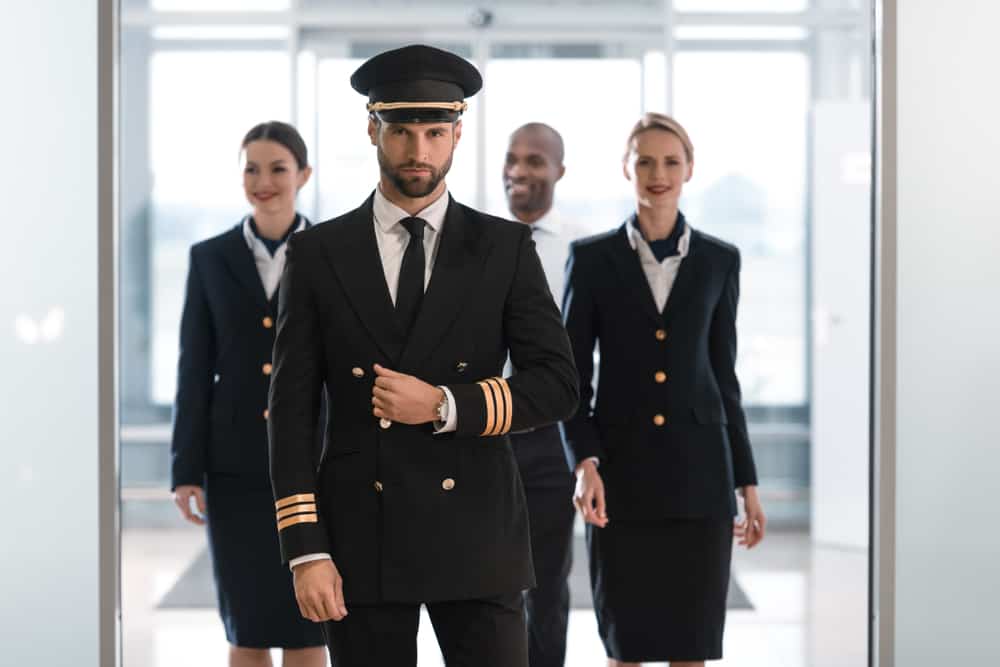 A pilot in uniform with his team.