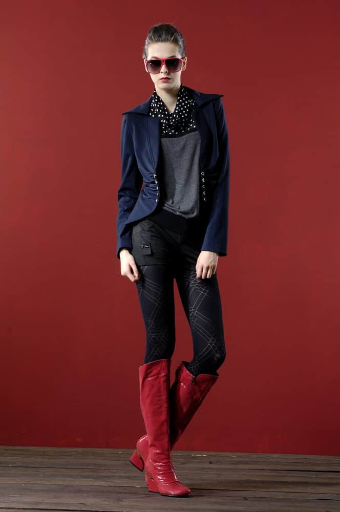 Fashion model wearing sunglasses and red wide calf boots.