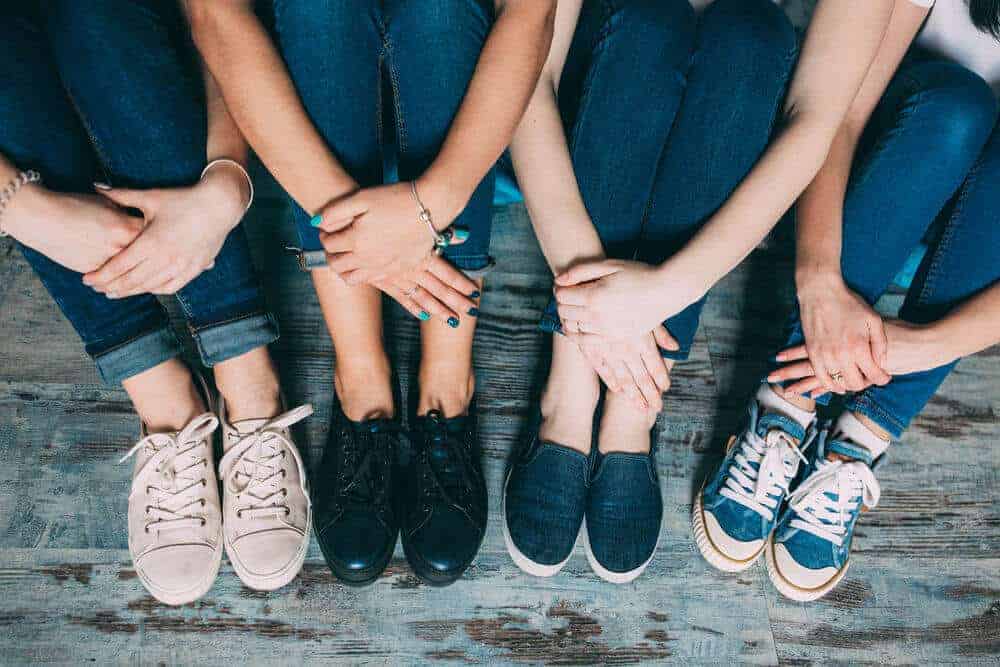 A group of friends with different types and styles of sneakers.