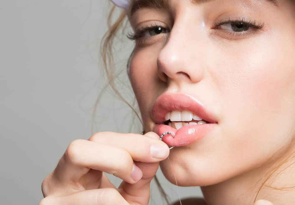 A woman flaunting her lip piercing.