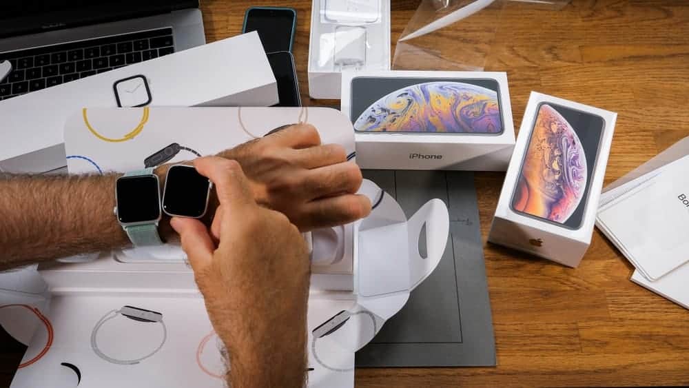 A man trying on his new Apple Watch GPS that he just unboxed.