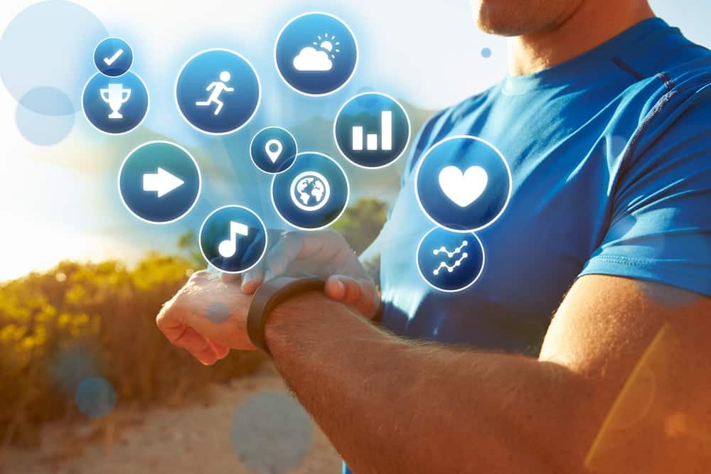 A man checking his fitness tracker after exercising.
