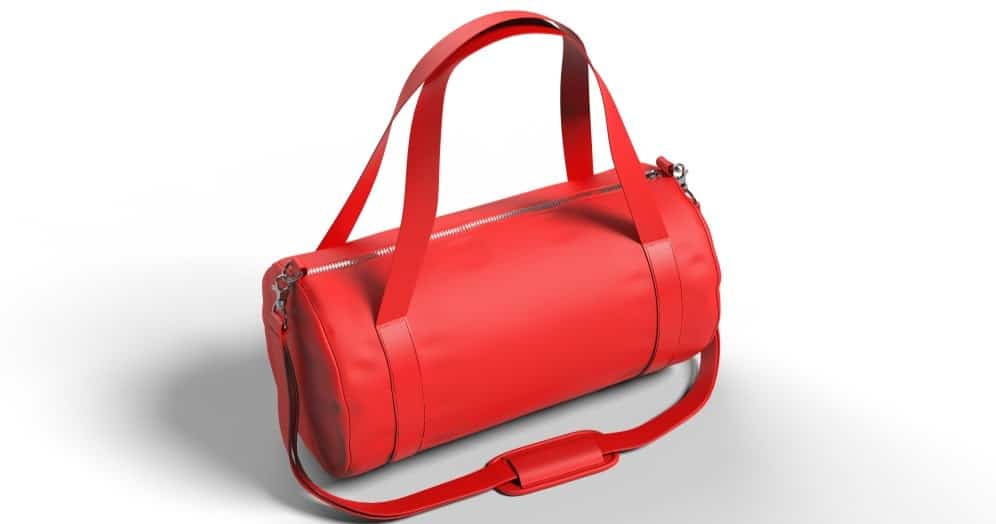 A close look at a woman's barrel bag in red leather.