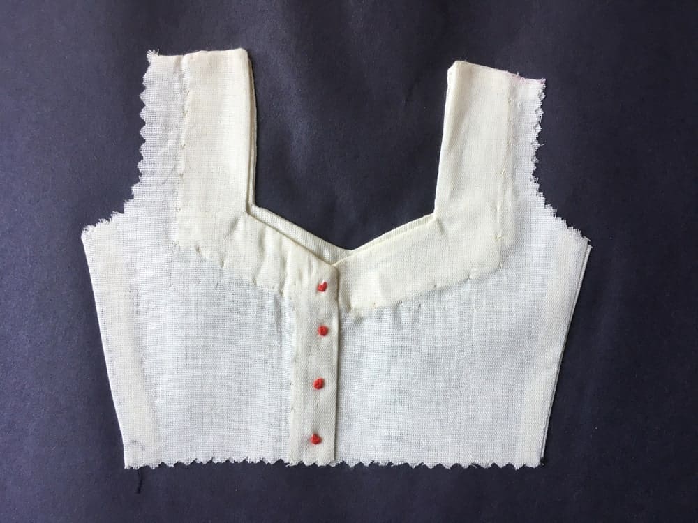 A close look at a blouse with a sweetheart neckline.