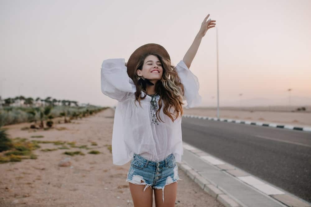 A woman wearing a long white blouse.