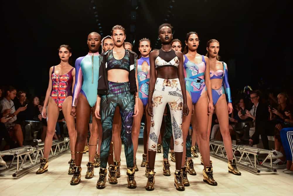 This is a fashion show that features models wearing swimsuits and yoga pants.