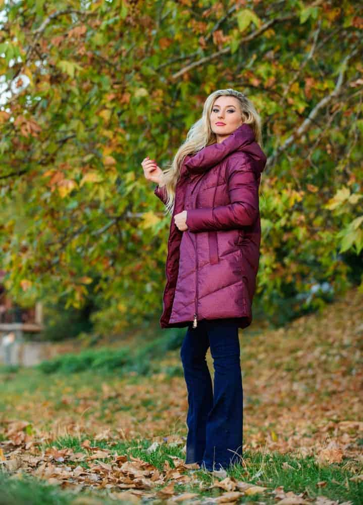 A woman wearing a brightly-colored puffer jacket.