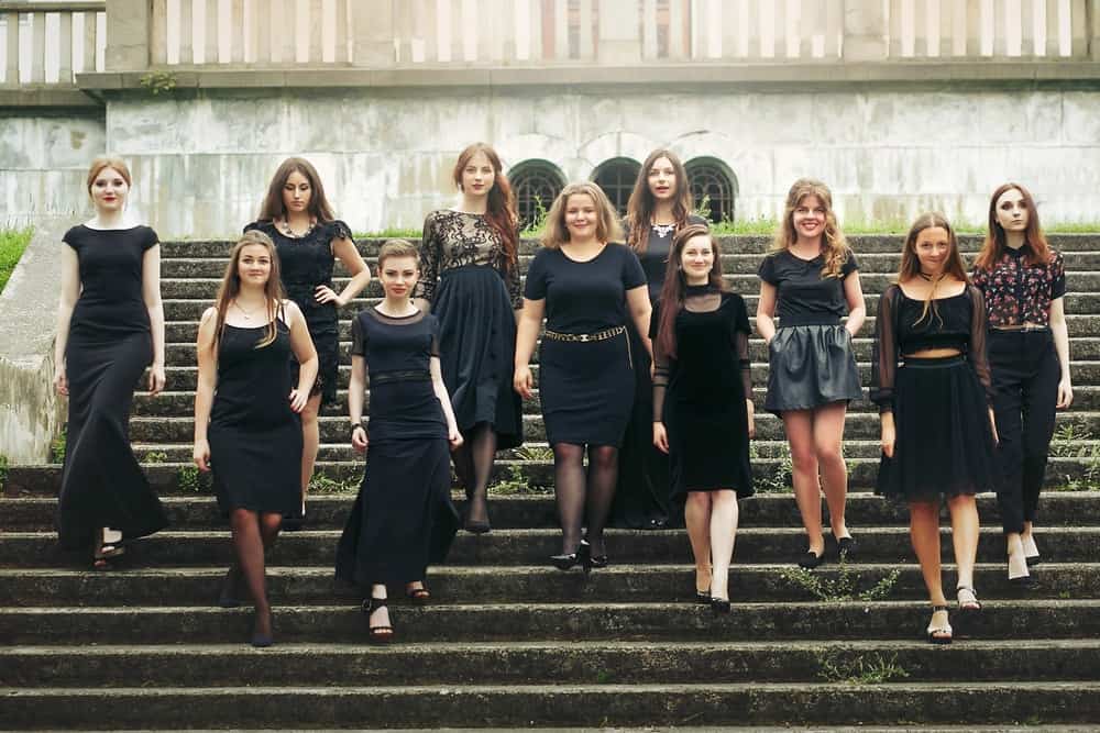A group of women wearing black outfits.