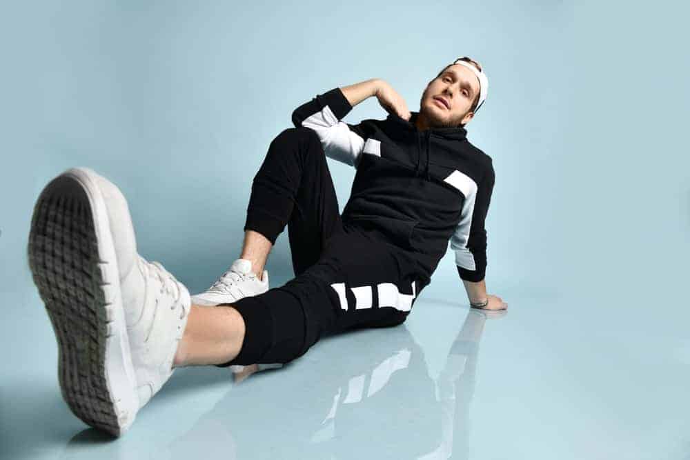 A man wearing a black and white tracksuit.