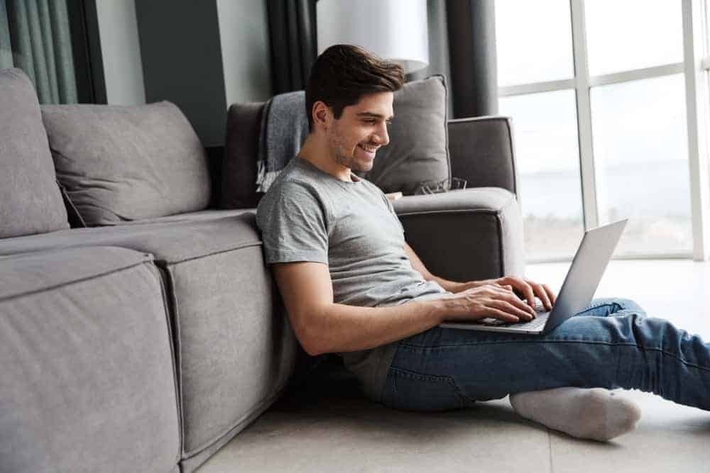 A man lounging in the living room with a linen shirt.