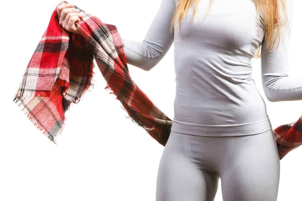 A close look at a woman wearing a set of white thermal underwear.