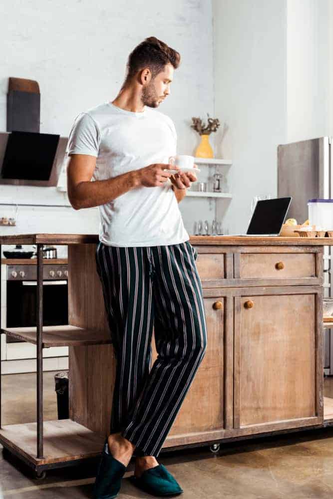 Man wearing t-shirt and pajama bottoms