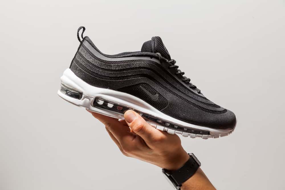 Man holding Nike Air Max shoe.