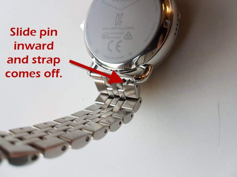 A close look at a Fossil Q smartwatch showcasing the instruction on how to change strap.