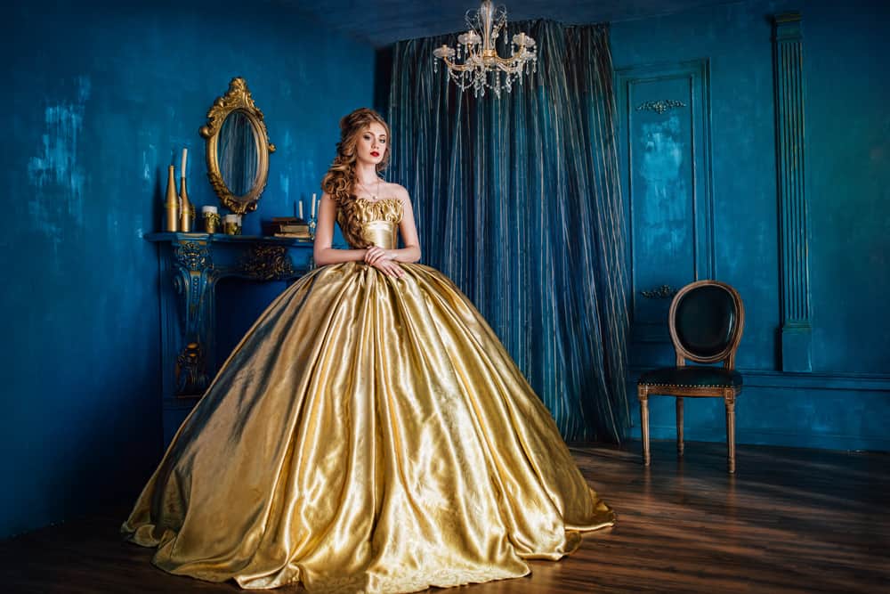 Woman wearing a stunning gold ball gown.