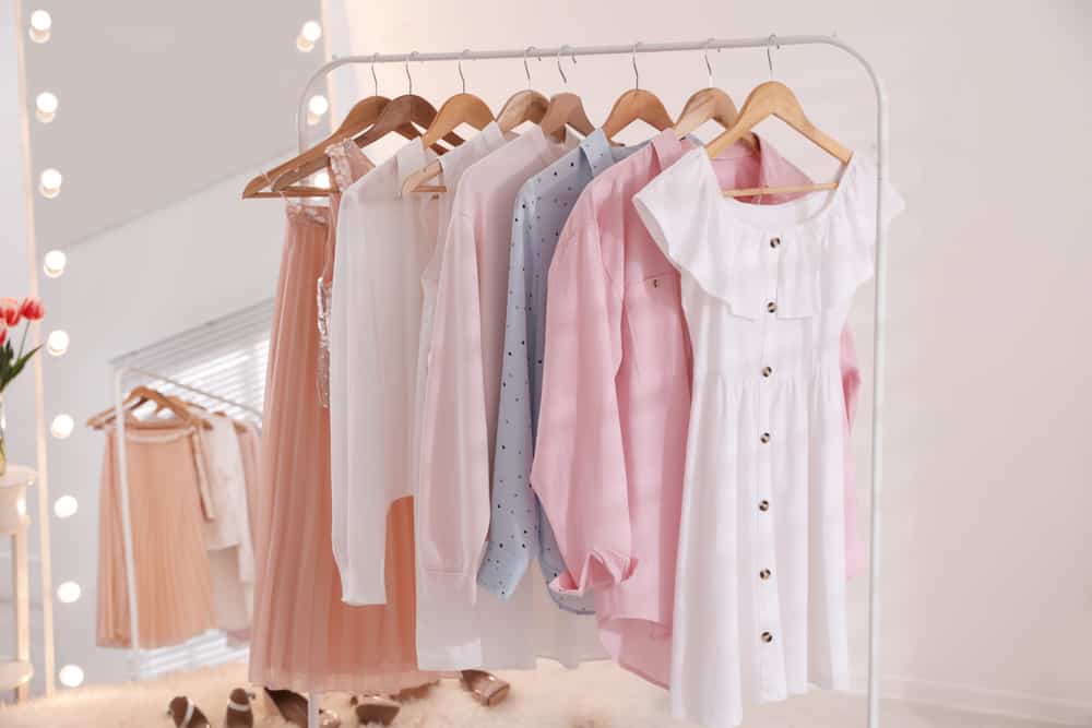A rack of women's clothes in a dressing room.