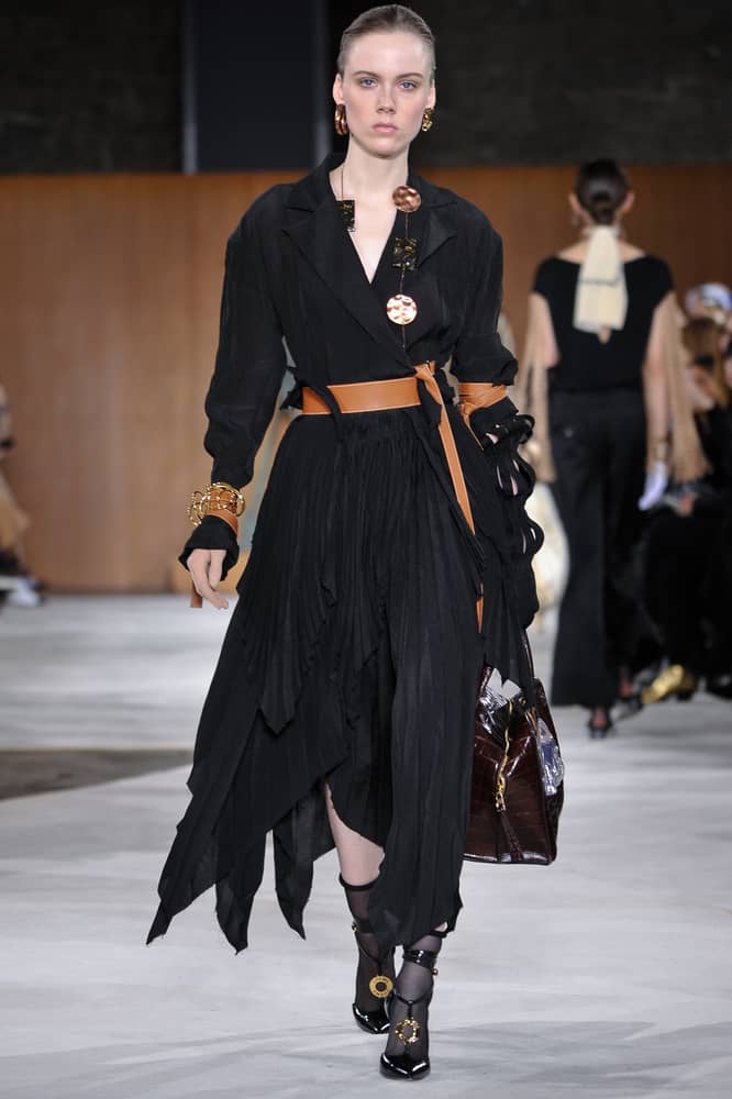 Model in a handkerchief dress walks the runway.