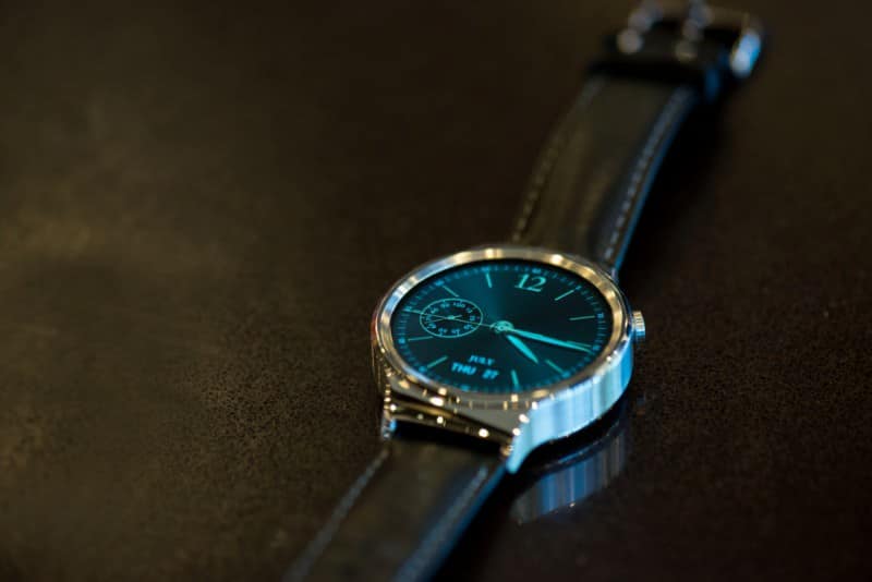 The Huawei smartwatch on a wooden table.