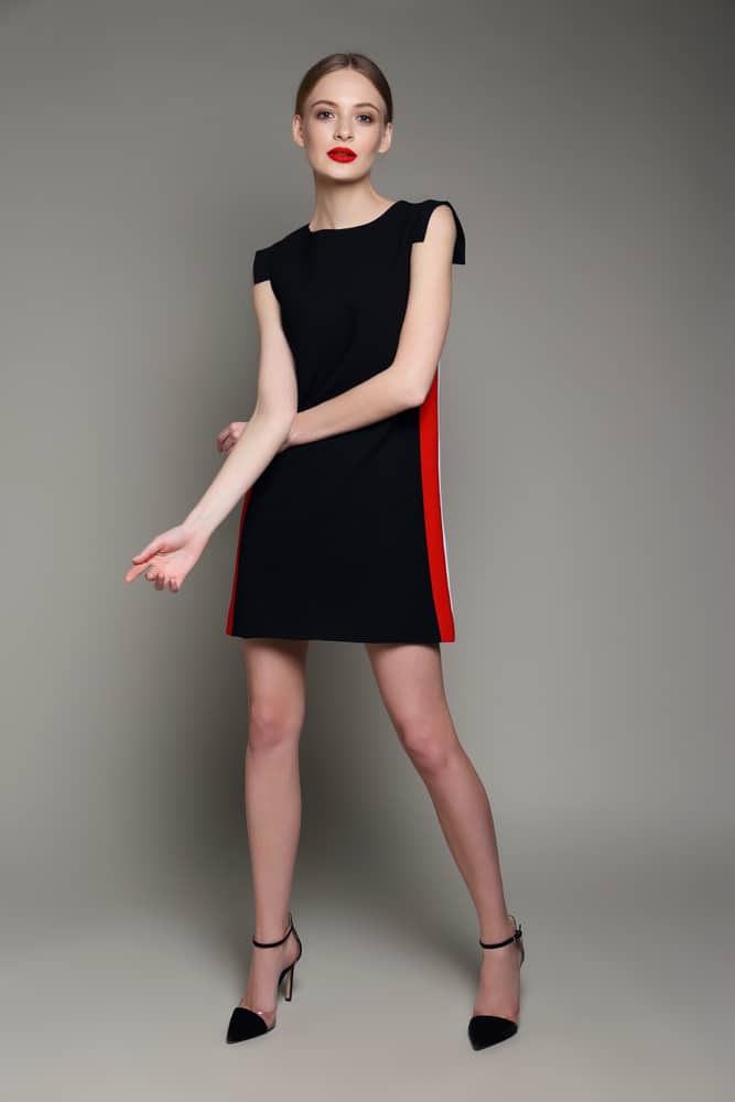 Woman in short black shift dress.