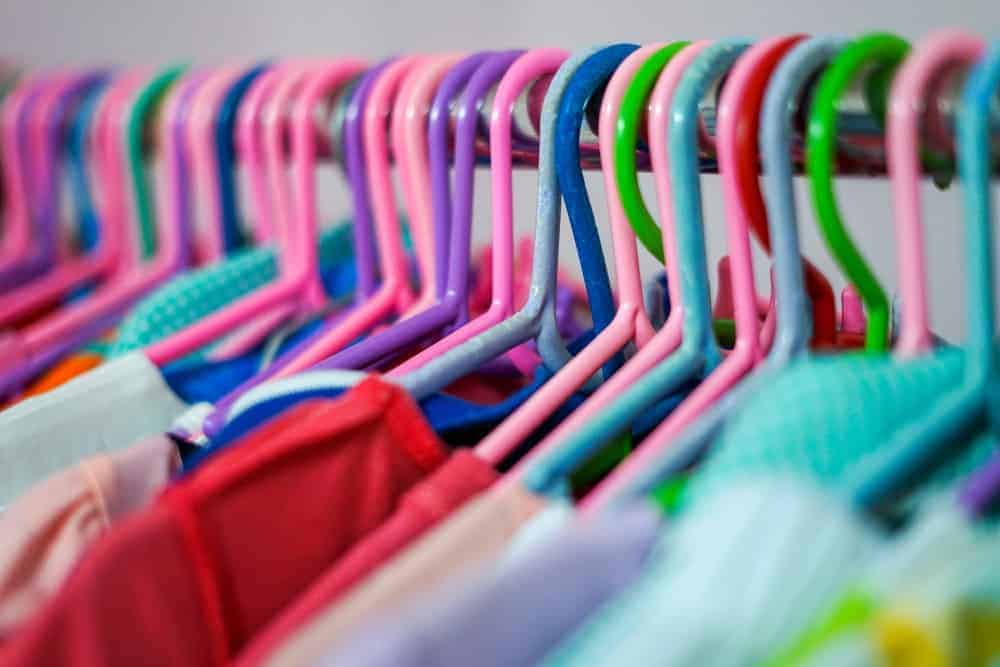 This is a close look at a row of plastic hangers on a rack.
