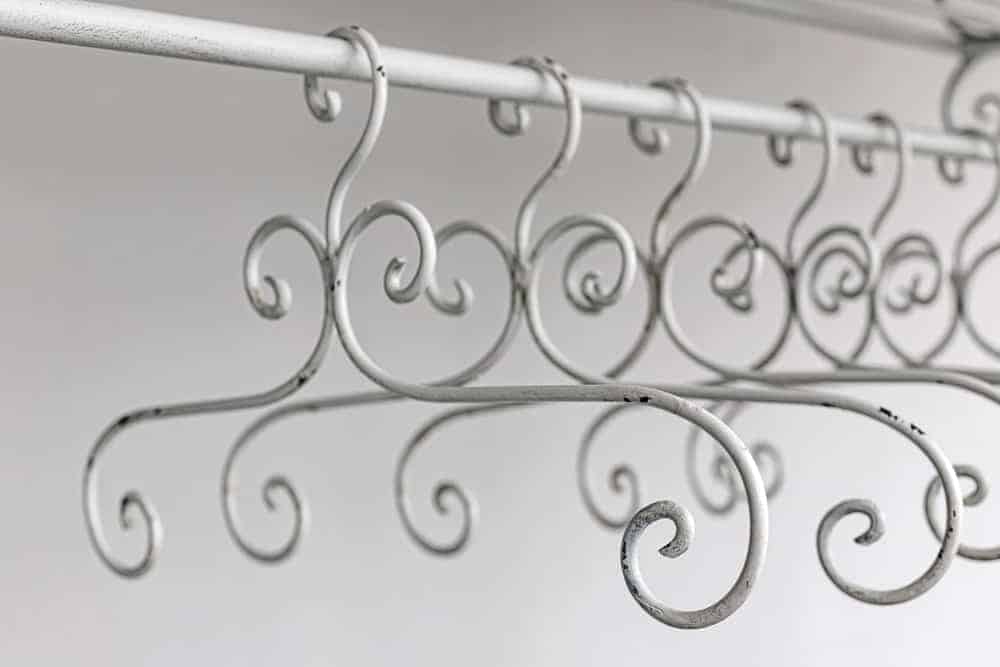 A close look at a row of vintage metal hangers.
