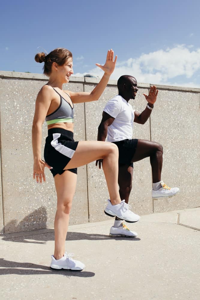 A couple wearing shorts while exercising.