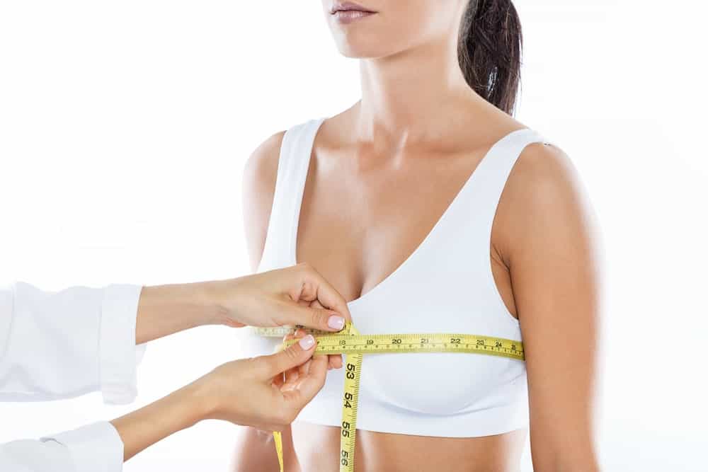 A woman having her chest measured.