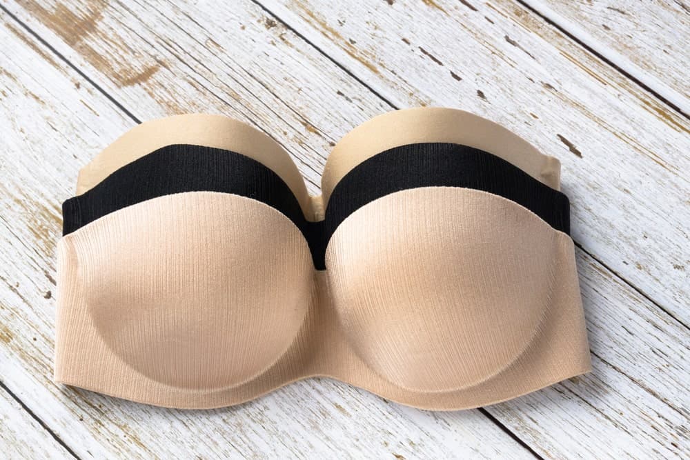 Balconette bras on a wooden table.