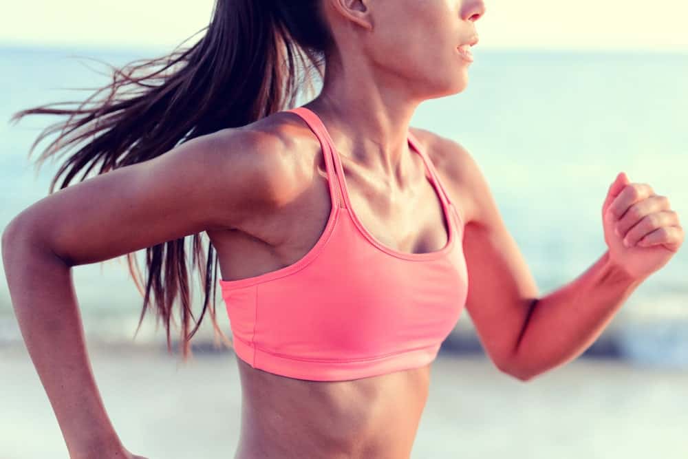 A runner wearing a pink sports bra.