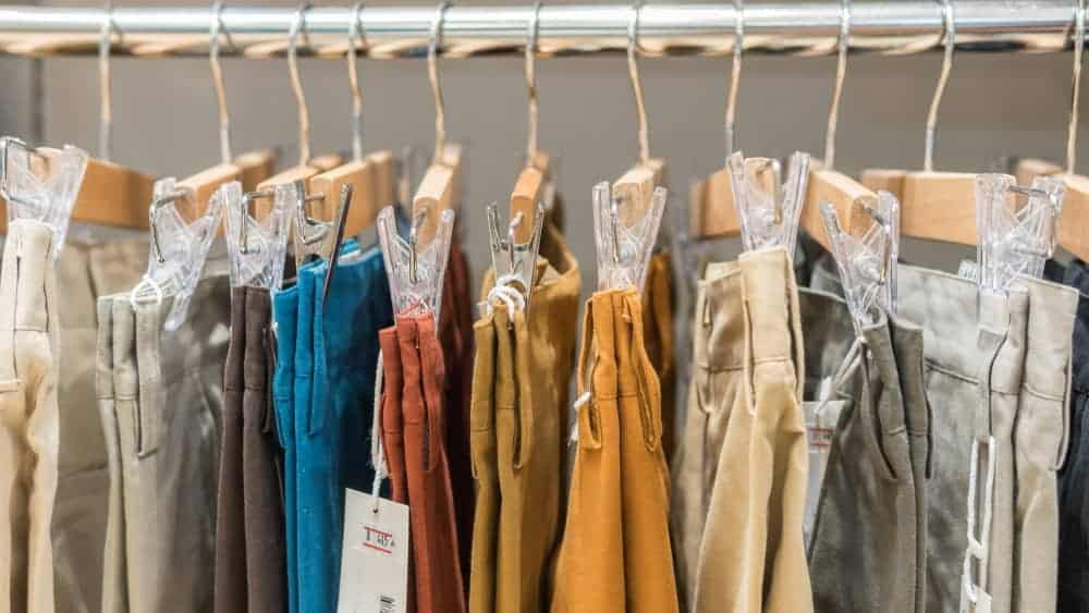 A rack of various chinos in display.