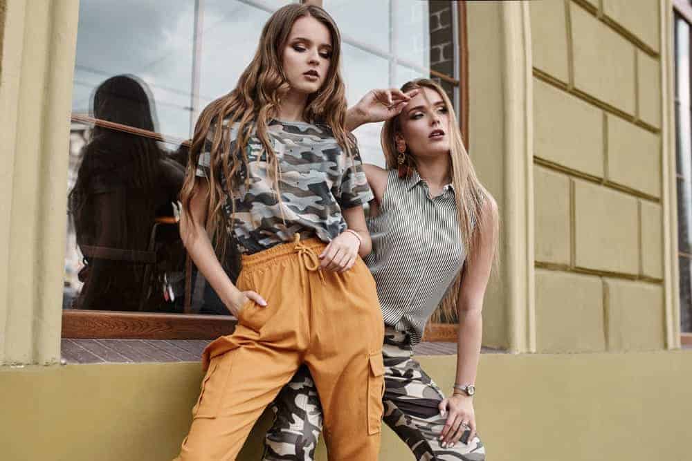 A couple of women posing with their khakis and military patterns.