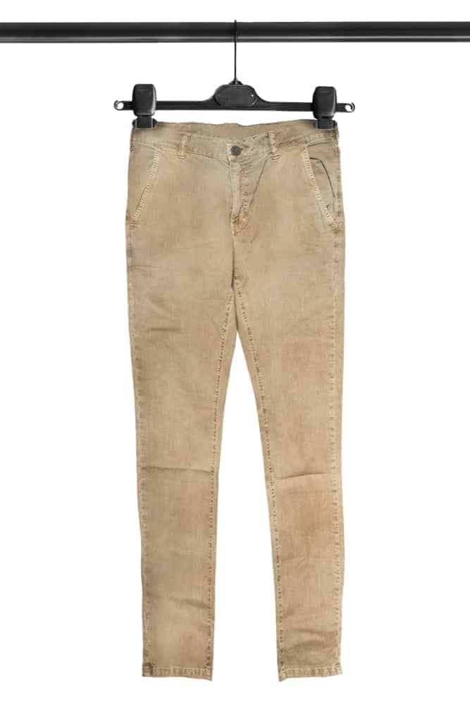 A close look at a pair of khaki pants on a hanger.