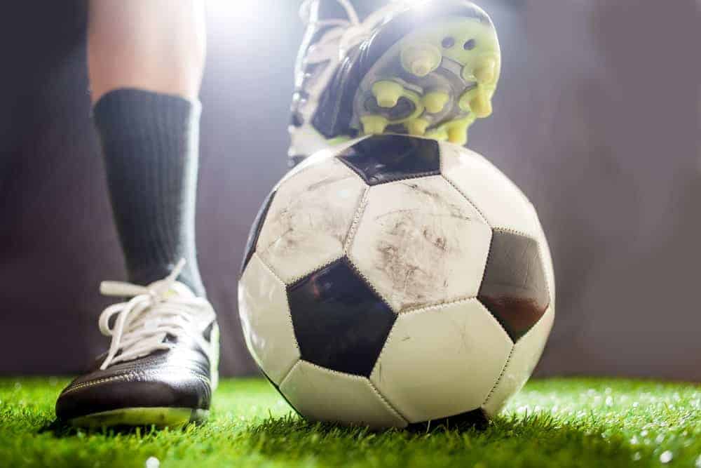 A close look at the feet of a soccer player.