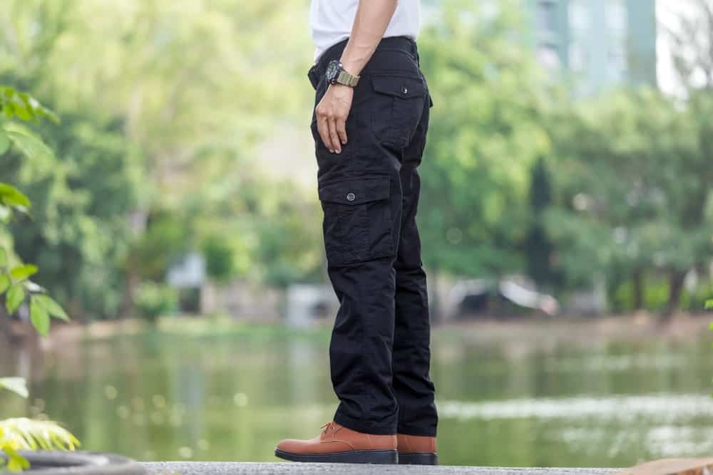 A close look at a man wearing black cargo pants.